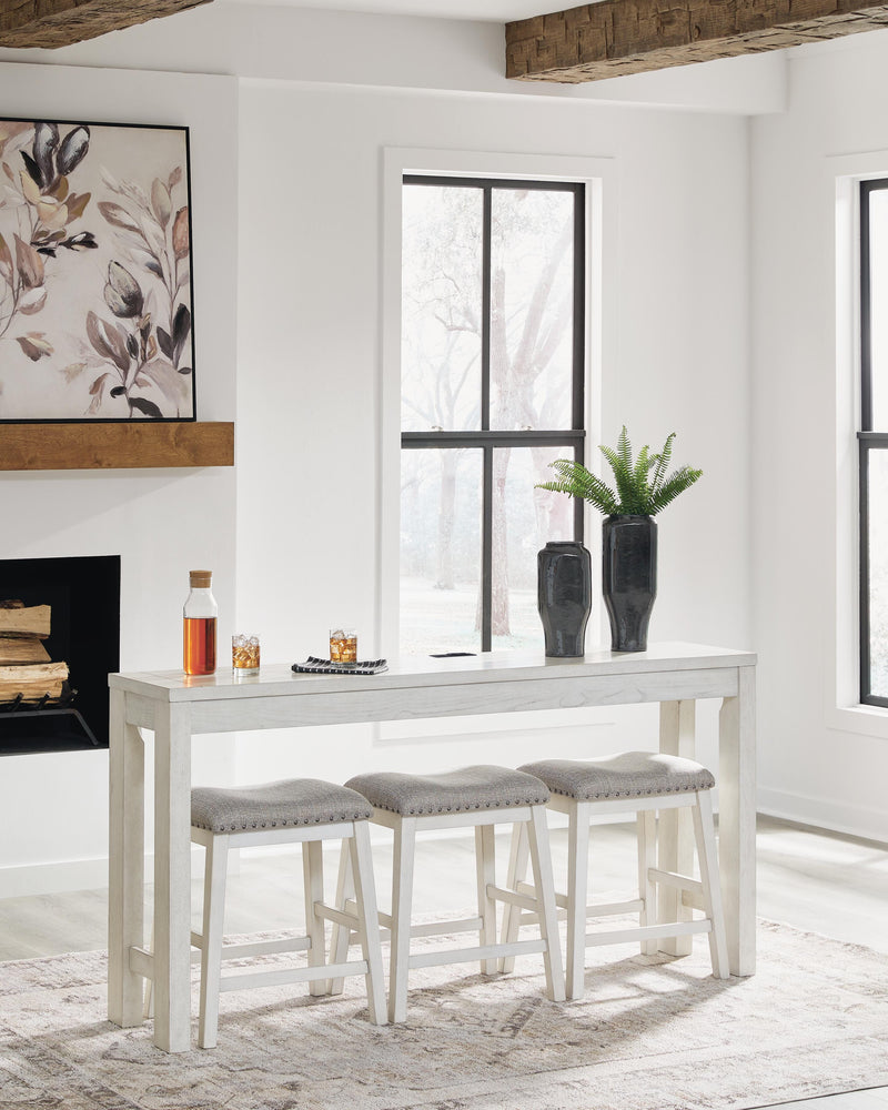 Ashley Furniture Robbinsdale counter height dining table with three matching barstools, featuring a sleek wood finish and modern design.