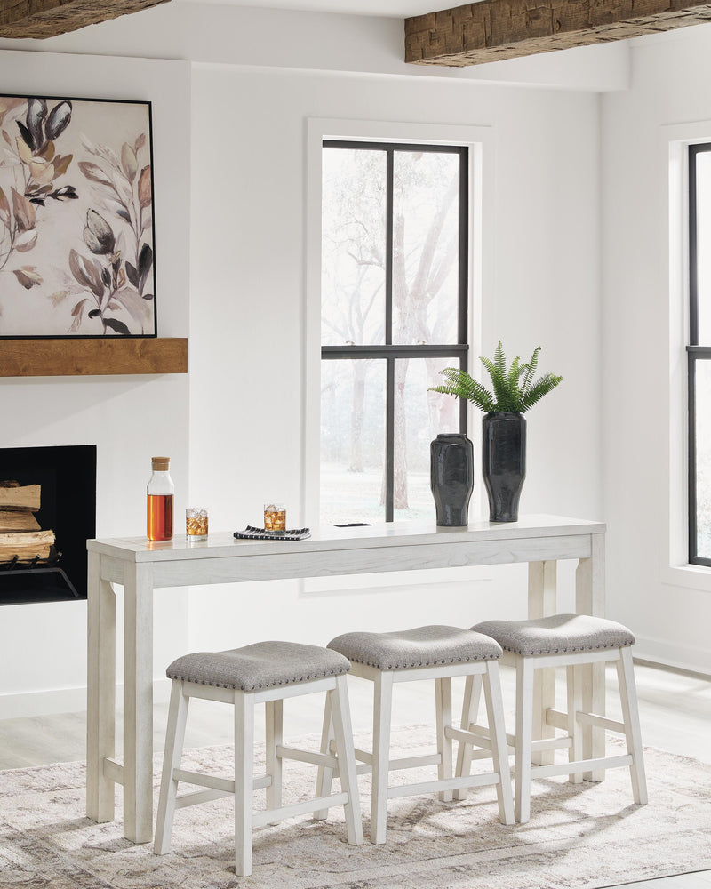 Ashley Furniture Robbinsdale counter height dining table with three matching barstools, featuring a stylish wooden finish and modern design.