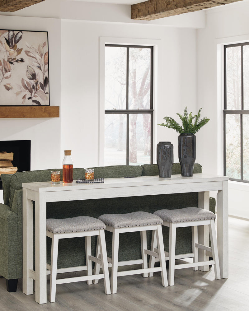 Ashley Furniture Robbinsdale counter height dining table with three matching barstools, featuring a sleek wood finish and modern design.