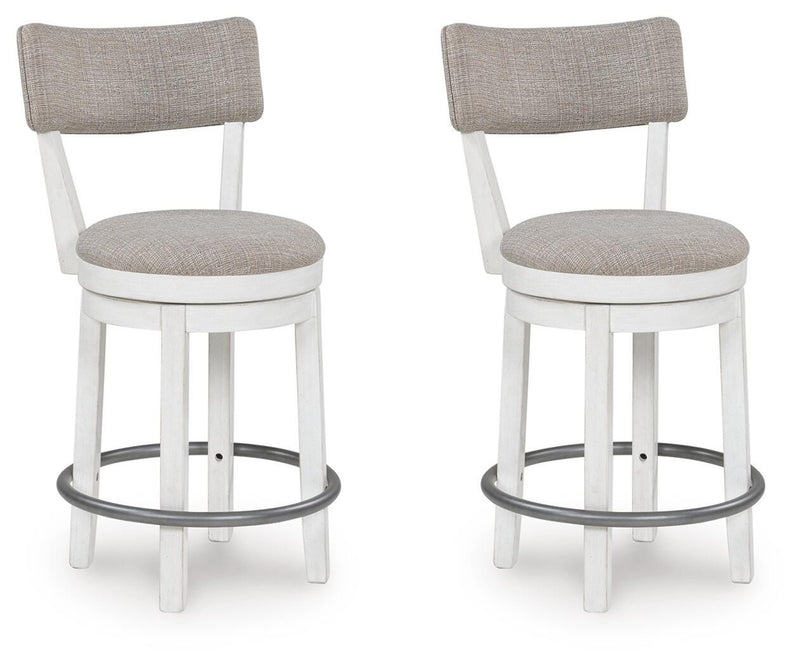 Two Robbinsdale counter height barstools by Ashley Furniture with wooden legs and upholstered seats, angled view.
