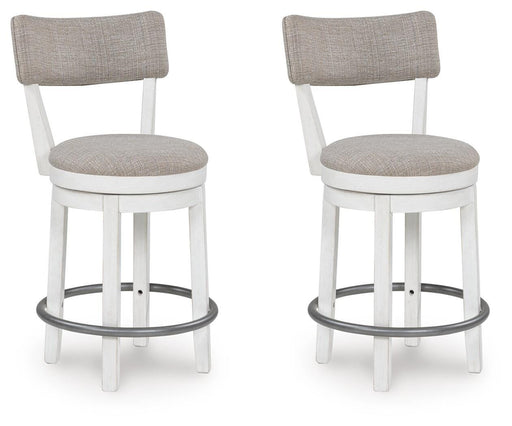 Two Robbinsdale counter height barstools by Ashley Furniture with wooden legs and upholstered seats, angled view.
