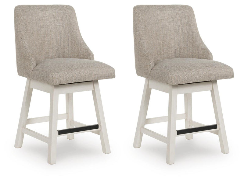 Set of two Robbinsdale counter height barstools by Ashley Furniture with wooden legs and cushioned seats, angled view.