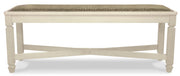Ashley Furniture Bolanburg dining bench with wooden legs and upholstered seat, shown from a head-on angle.