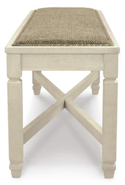 Ashley Furniture Bolanburg dining room set with a wooden table and six matching chairs, shown in a modern dining space.