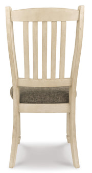 Ashley Furniture Bolanburg dining room set with a table and matching chairs, shown from the back in this image.