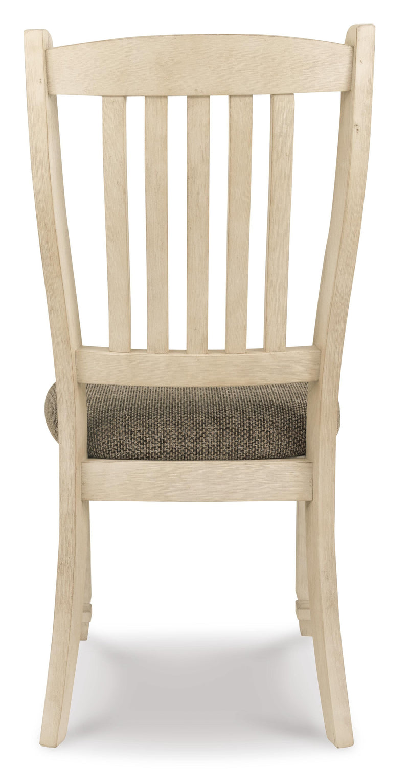 Ashley Furniture Bolanburg dining room set with a table and matching chairs, shown from the back in this image.