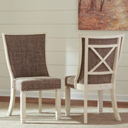 Set of Ashley Furniture Bolanburg dining chairs, featuring upholstered seats and wooden legs, arranged around a dining table.