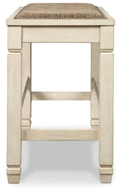 Ashley Furniture Bolanburg counter height dining bench with wooden legs and upholstered seat, shown from a side angle.