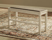 Ashley Furniture Bolanburg counter height dining bench with wooden frame and upholstered seat, shown in a modern dining room setting.