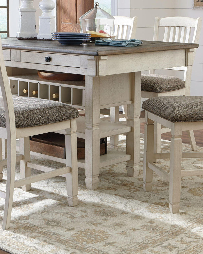 Ashley Furniture Bolanburg counter height dining table with a wooden finish and sturdy legs, shown from a side angle.
