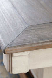Close-up of the Ashley Furniture Bolanburg counter height dining table top, showcasing the wood grain and finish details.