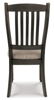Ashley Furniture Tyler Creek dining room set with a rectangular table and six upholstered chairs, shown from the back.