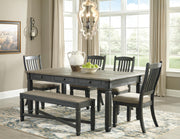 Ashley Furniture Tyler Creek dining room set with wooden table and six matching chairs arranged in a modern dining space.