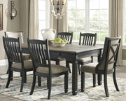 Ashley Furniture Tyler Creek dining room set with a wooden table and six matching chairs, shown in a modern dining space.