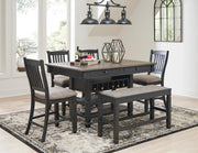 Ashley Furniture Tyler Creek counter height dining set with wooden table and matching chairs in a modern dining room.