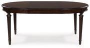 Ashley Furniture Lavinton dining extension table with leaf, wood finish, and sleek design, shown from head-on view.