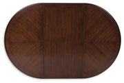 Ashley Furniture Lavinton dining extension table with a polished wood top and a leaf extension, ideal for flexible dining spaces.
