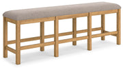 Ashley Furniture Havonplane 72-inch counter height dining bench with wooden legs and upholstered seat, angled view.
