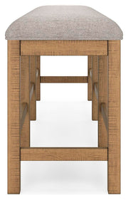 Ashley Furniture Havonplane 72-inch counter height dining bench with wooden legs and upholstered seat, shown from side view.