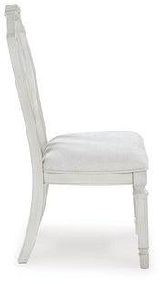 Ashley Furniture Montelaine dining chair with beige upholstered seat and wooden legs, shown from a side view.