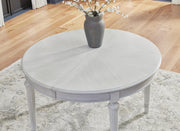 Ashley Furniture Montelaine formal dining room set with a wooden table and leaf extension, surrounded by elegant upholstered chairs.