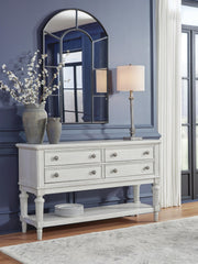 Ashley Furniture Montelaine dining server with wood finish and multiple storage compartments, shown in a cropped image.