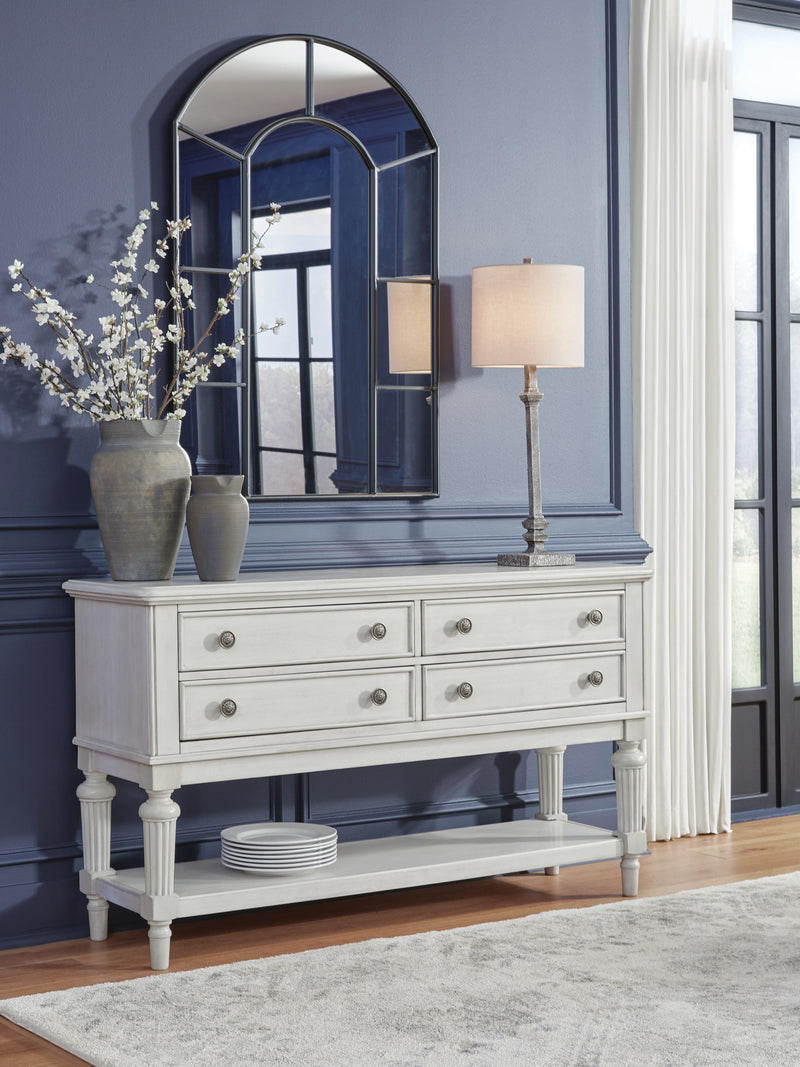 Ashley Furniture Montelaine dining server with wood finish and multiple storage compartments, shown in a cropped image.