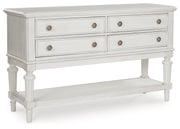 Ashley Furniture Montelaine dining server with closed doors, wood finish, and elegant design, showcasing ample storage space.
