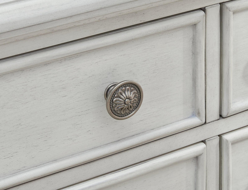 Ashley Furniture Montelaine dining server with detailed knob hardware and elegant wood finish, showcasing its storage and design features.