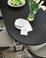 Close-up of the Ashley Furniture Rowanbeck Dining Package, featuring a wooden dining table and matching chairs with detailed craftsmanship.