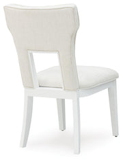 Ashley Furniture Chalanna dining room set with a wooden table and upholstered chairs, viewed from the back.