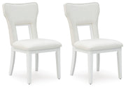 Ashley Furniture Chalanna dining chair with beige upholstered seat and dark wood legs, shown from an angled side view.