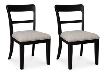 Ashley Furniture Greddinton dining room set with a wooden table and six upholstered chairs, shown from an angled side view.