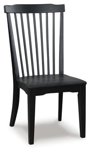 Ashley Furniture Greddinton dining room set with a wooden table and matching chairs, shown from an angled perspective.