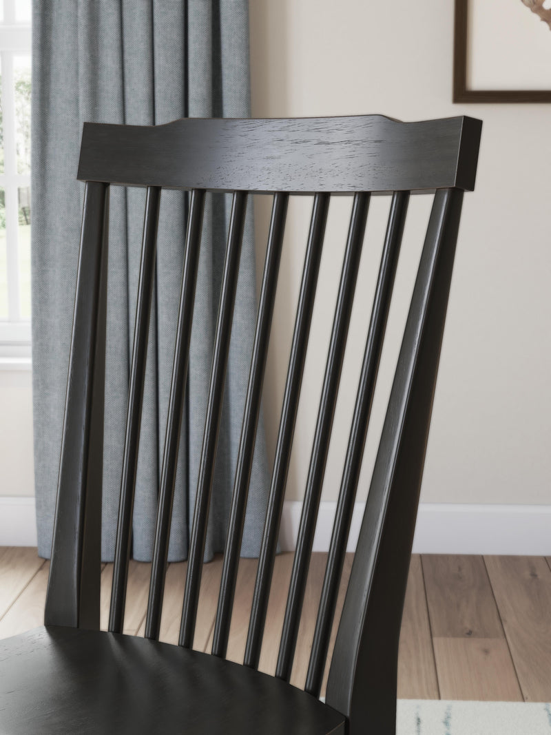 Ashley Furniture Greddinton dining room set featuring a wooden table and matching chairs with intricate design details.
