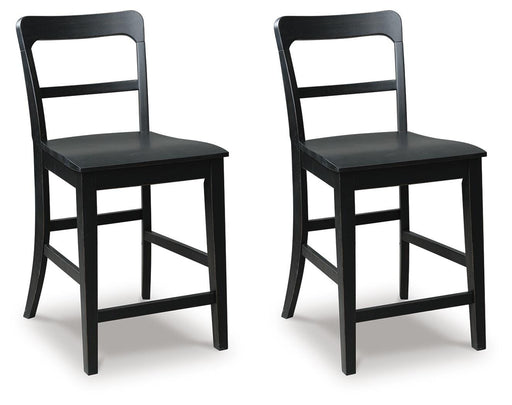 Ashley Furniture Greddinton counter height barstool with wooden legs and cushioned seat, shown from an angled side view.