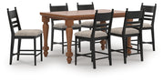 Ashley Furniture Greddinton dining room set with a wooden table and matching chairs in a modern dining space.