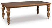 Ashley Furniture Greddinton dining room set with a wooden table and upholstered chairs, viewed from an angled side perspective.
