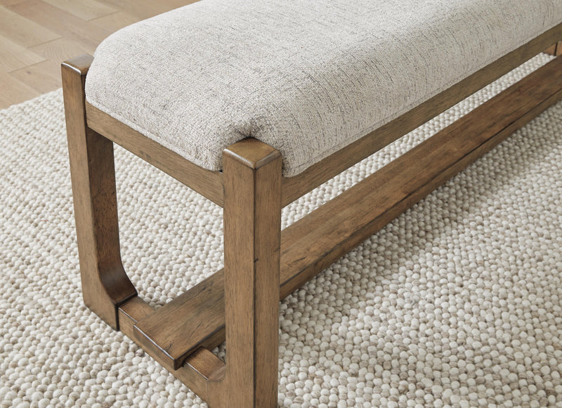 Ashley Furniture Cabalynn 63-inch wood dining bench with a sleek, modern design and sturdy construction.