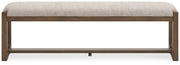 Ashley Furniture Cabalynn 63-inch wooden dining bench with a cushioned seat and elegant design, ideal for kitchen or dining room.