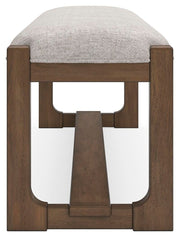 Ashley Furniture Cabalynn 63-inch wooden dining bench with a sleek design, shown from a side angle in the image.