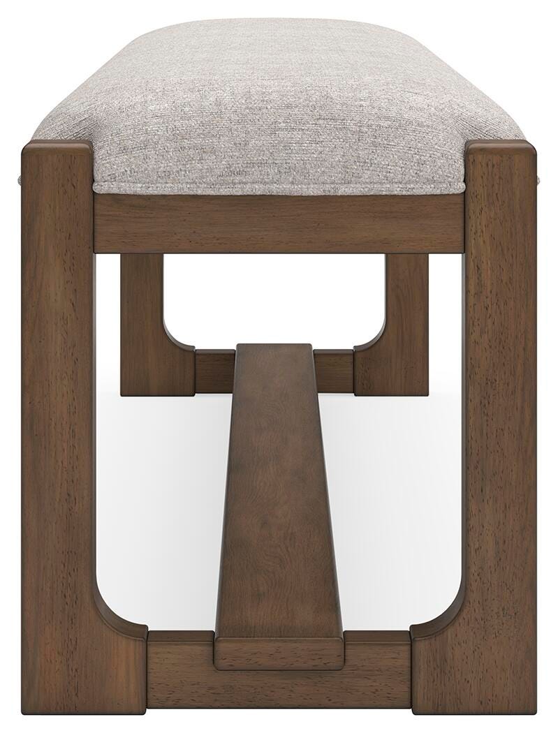 Ashley Furniture Cabalynn 63-inch wooden dining bench with a sleek design, shown from a side angle in the image.