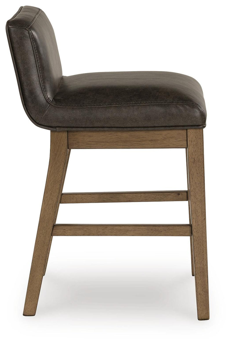 Ashley Furniture Cabalynn counter height barstool with upholstered seat and wooden legs, shown from a side angle.