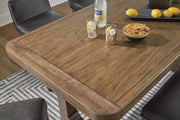 Close-up of the Ashley Furniture Cabalynn counter height dining table top showing wood grain and detailed finish.
