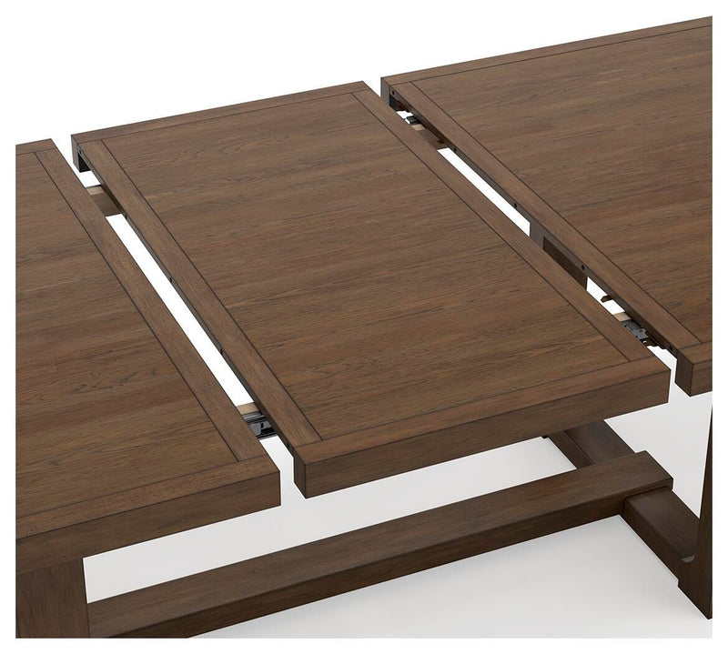 Ashley Furniture Cabalynn dining extension table with leaf detail, showcasing its elegant wood finish and classic design.