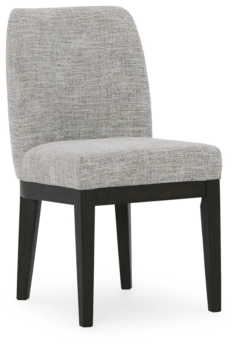 Ashley Furniture Burkhaus dining room set with a wooden table and matching chairs, viewed from an angle.