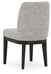 Ashley Furniture Burkhaus dining room set with a round table and upholstered chairs, shown from the back view.