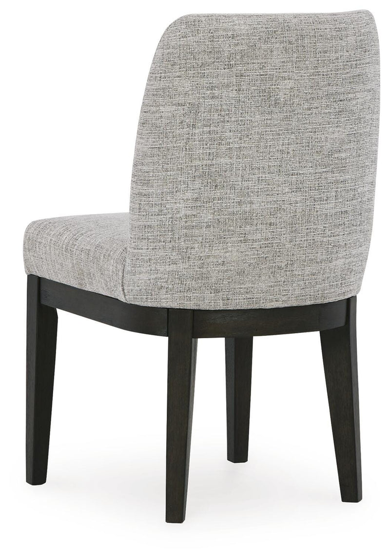 Ashley Furniture Burkhaus dining room set with a round table and upholstered chairs, shown from the back view.
