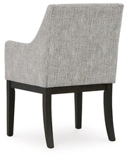 Ashley Furniture Burkhaus dining room set with a table and chairs, shown from the back in a modern dining space.