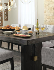 Close-up of Ashley Furniture Burkhaus Dining Extension Table top showing wood grain and detailed craftsmanship.